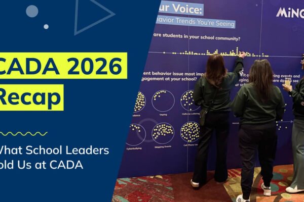 People putting stickers on the Minga engagement wall at the CADA 2026 conference