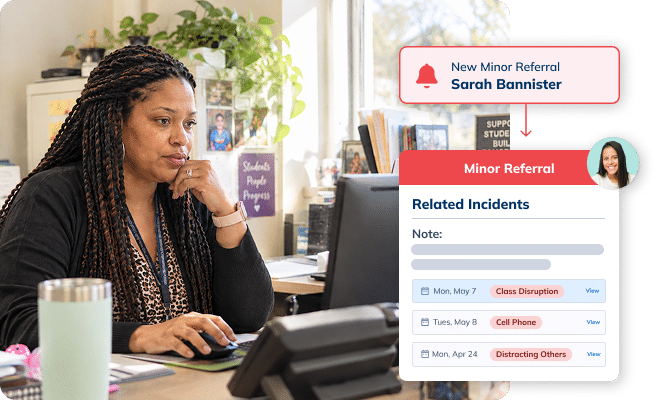 School administrator reviewing minor referral records in Minga at her desk.