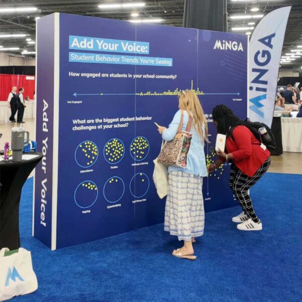 School leaders leaving stickers on Minga's engagement wall at TASSP summer conference 2026