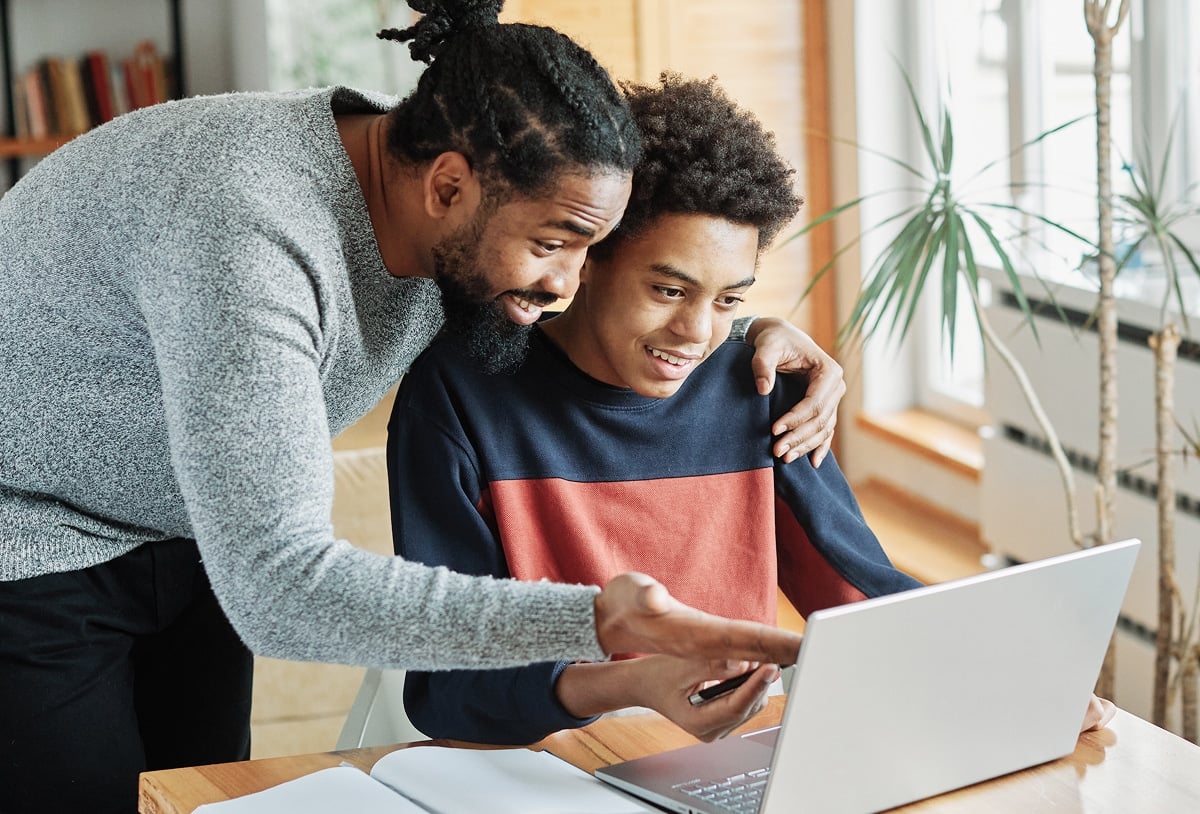 Parent with child reviewing school progress.